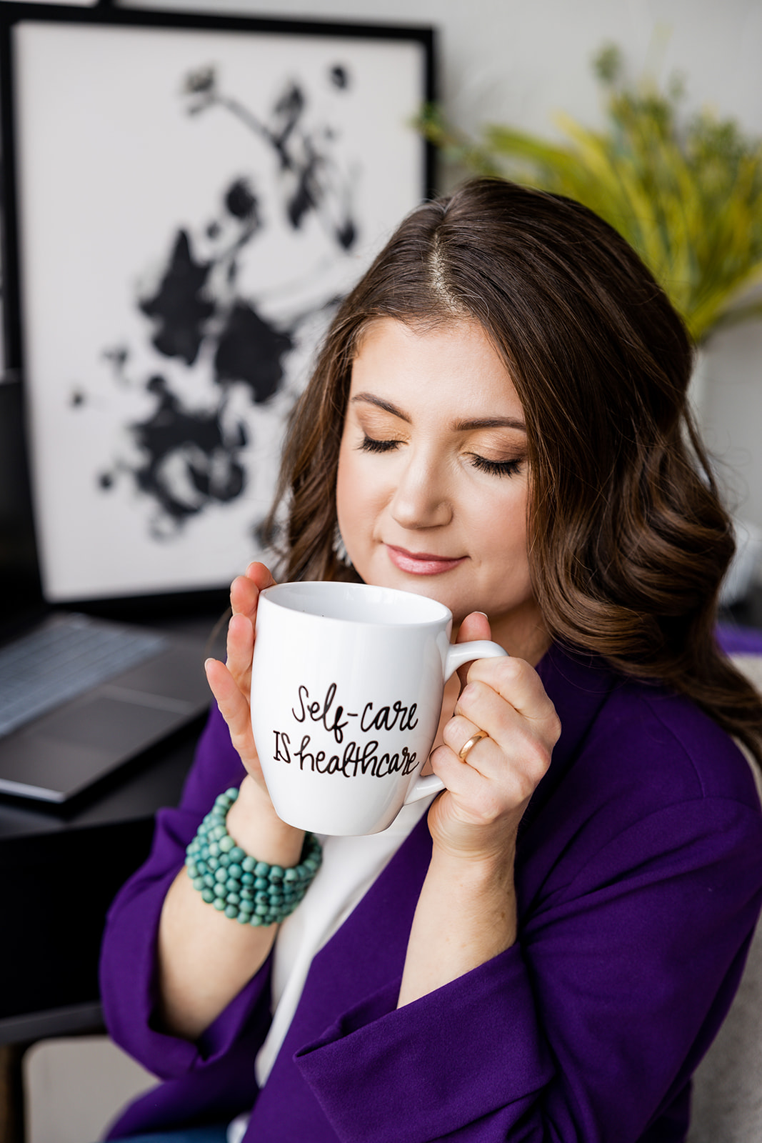 Adriane sipping Self-Care is Healthcare mug